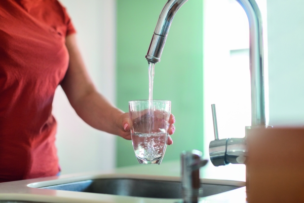womanfillsglassofwateratsink20260324031659utc.jpg