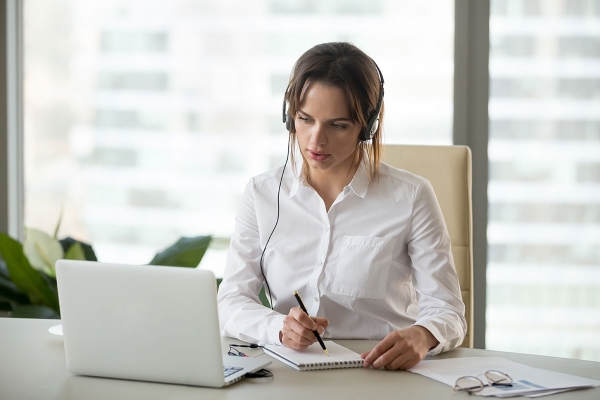 107344085seriousbusinesswomaninheadphoneswatchingwebinar.jpg